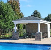12x20 Avalon with vinyl cedar shake siding, cobble stone post wraps and lower wall, curved trim