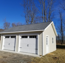 20x24 7 Pitch Truss Garage With 9 lite Door and Vinyl siding and Glass Inserts in Garage Door Extra 24x36 Window with Trim