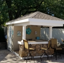 8x12 Siesta with vinyl siding, cobble stone bar front and 3