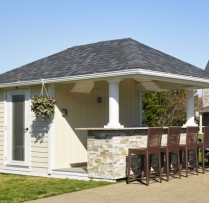 10x14 Siesta with smooth lapp siding, custom stone on bar, 3' overhang, gutters, custom prehung door